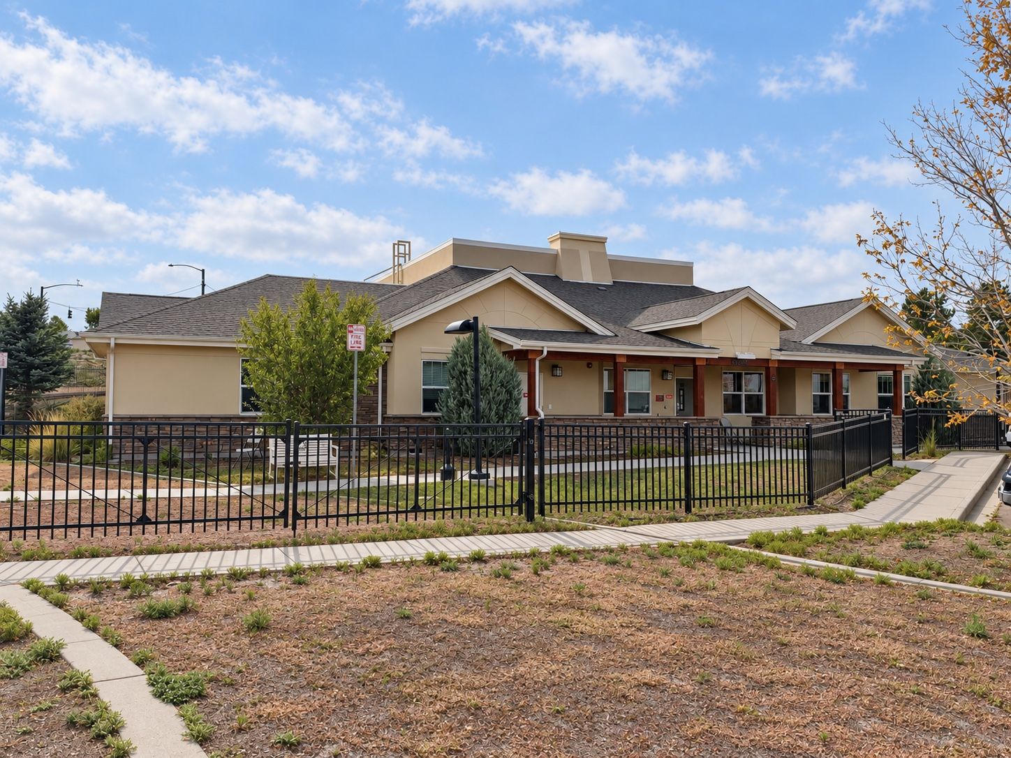 A side elevation of a Spring Grove Recovery building in Colorado Springs, Colorado, seen across the lawn