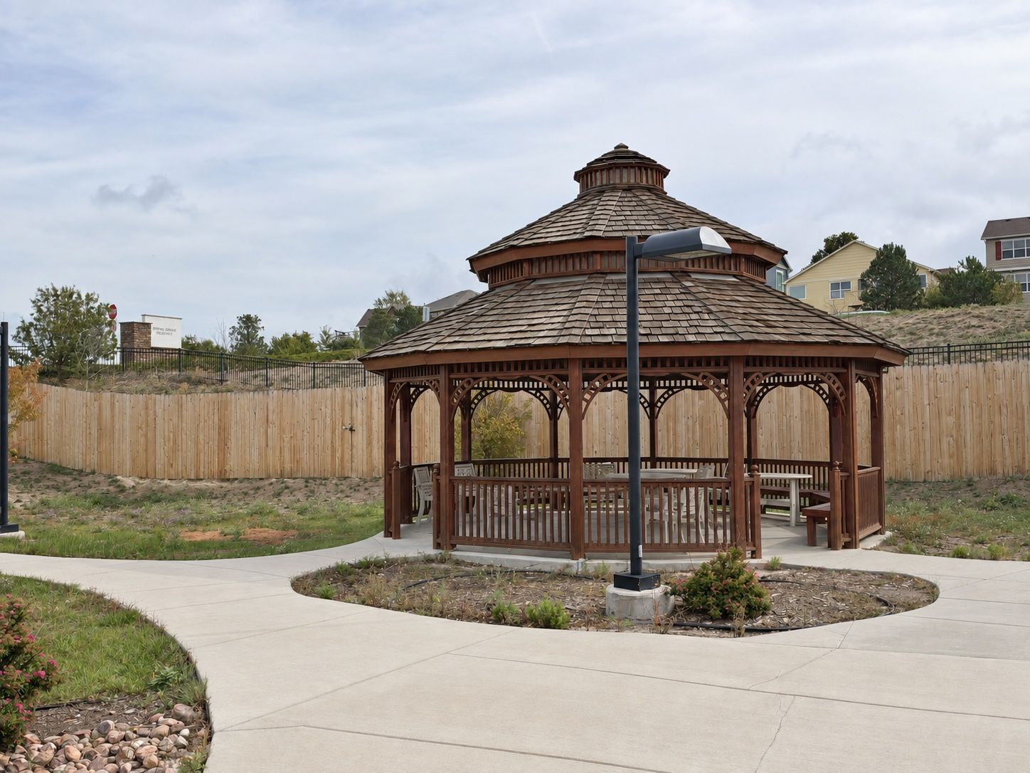 A wooden gazebo on the grounds at Spring Grove Recovery in Colorado Springs, Colorado, reached by a curving path