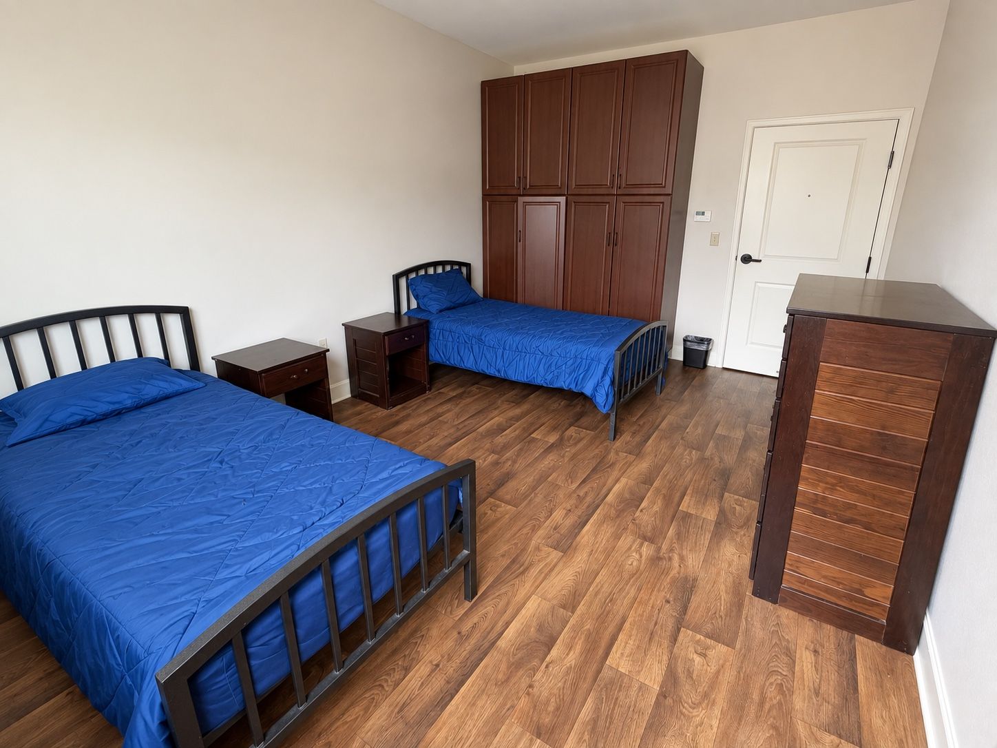 A resident room at Spring Grove Recovery in Colorado Springs, Colorado, with two beds, a wardrobe and a dresser