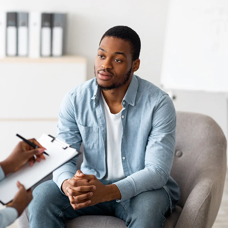 a man opens up to his counselor in therapy for addiction and mental health