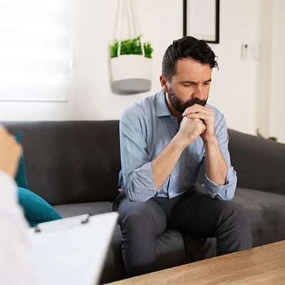 a man gets emotional in an addiction therapy session