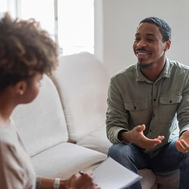 a smiling man is proud of the progress he is making in addiction treatment