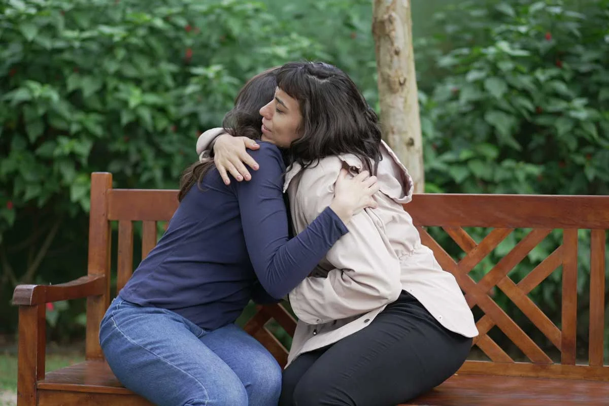 A woman hugs another woman. She is a family member who has decided to go into rehab at Spring Grove Recovery.