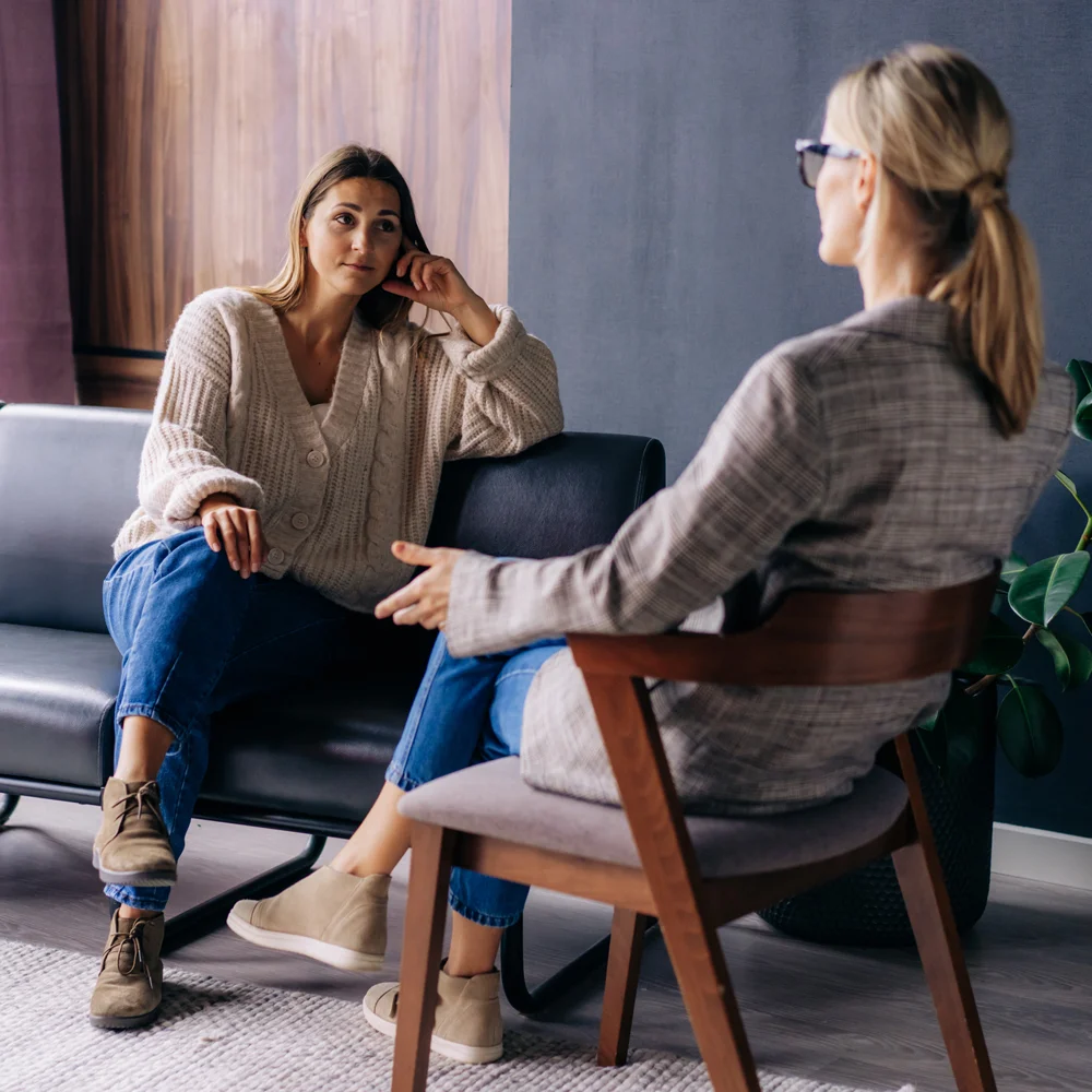 Women having discussion while sitting