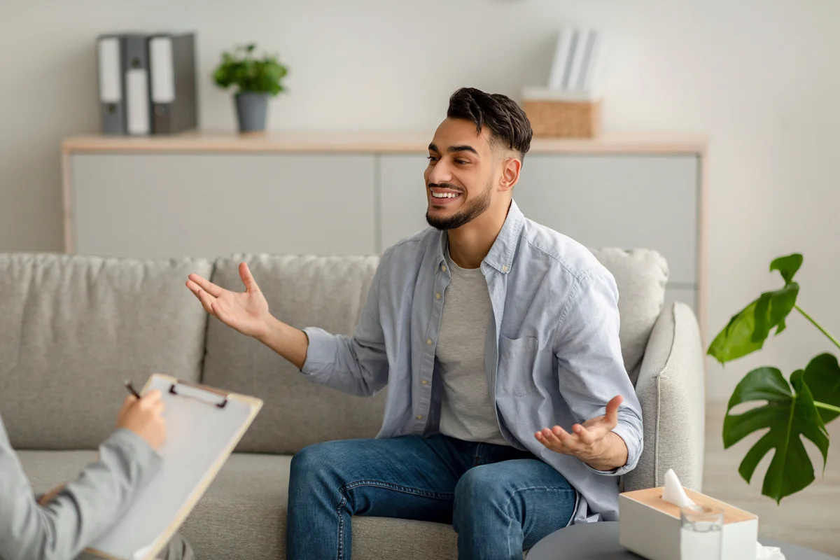 Man smiling while sitting on couch