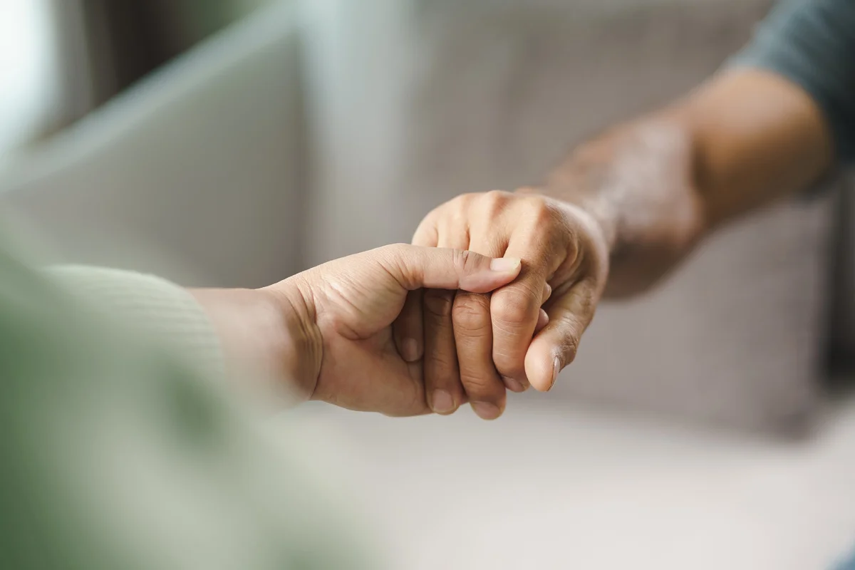 Holding hand in support