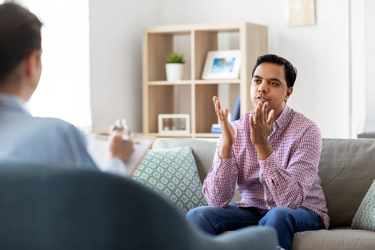 Man explaining something while sitting on couch