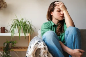 Woman holding head in pain