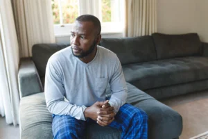 Man on couch tired