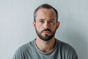 Disheveled man looking at camera
